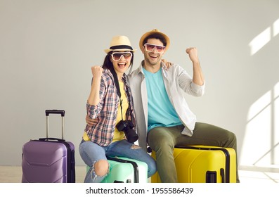 Joyful Couple Friends Travelers In Summer Clothes And Hat With Photo Camera, Suitcase Gesturing Yes Finally Vacation. Spouses Passenger Traveling Abroad On Weekend. Holiday Trip After Lockdown