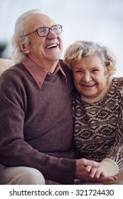 Joyful elderly man and woman in sweaters