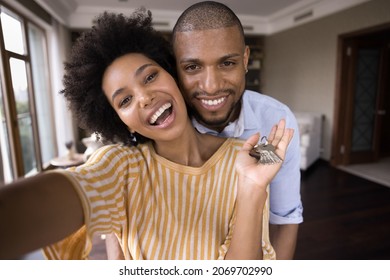 Joyful Emotional Bonding Young African American Married Couple Showing Keys To Camera, Making Selfie Photo Or Recording Video Streaming In Social Network, Celebrating Last Mortgage Payment At Own Home