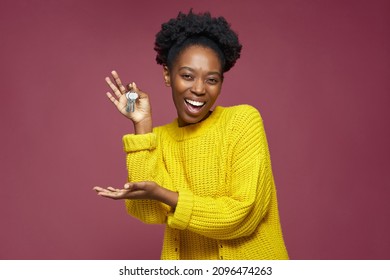 Joyful excited african american woman hold home key in hand buying modern apartment. Black woman win new flat in lottery - Powered by Shutterstock