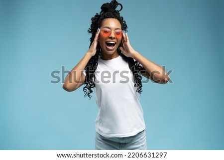 Joyful excited female in casual clothes enjoying leisure time in studio