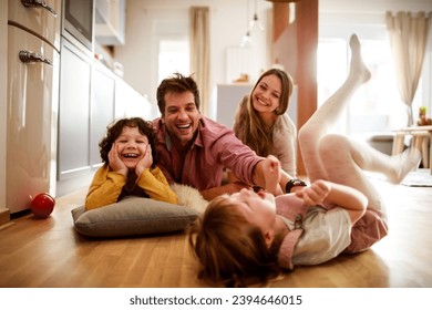 Joyful family playing together on the floor at home - Powered by Shutterstock