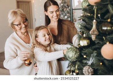 A joyful family scene of three generations decorating a Christmas tree together, capturing warmth, love, and festive spirit. Smiling women and child share a magical holiday bonding moment at home. - Powered by Shutterstock