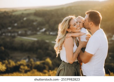 A joyful family shares a loving moment outdoors, embracing in a picturesque countryside setting during sunset. Perfect representation of happiness, love, and family bonding in nature. - Powered by Shutterstock