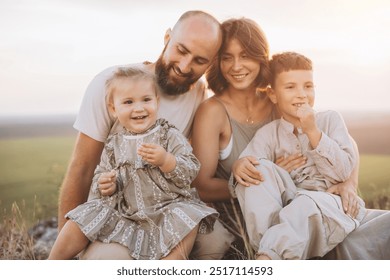 A joyful family shares quality time outdoors during a beautiful sunset. The scene depicts love, unity, and happiness under warm, golden light. - Powered by Shutterstock