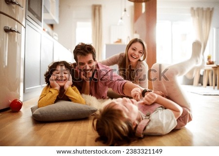 Joyful family sharing a playful moment in their living room