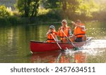 Joyful family of three canoeing on a calm river, with splashing water and lush greenery illuminated by sunlight at summer in bavaria, germany. Family on kayak ride. Wild nature and water fun on summer