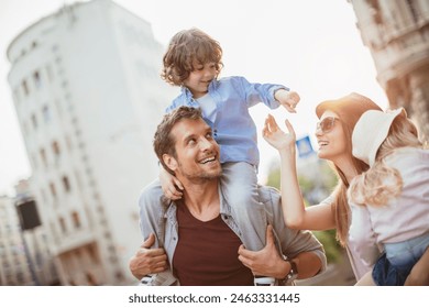 Joyful family with young children shopping and walking in the city - Powered by Shutterstock