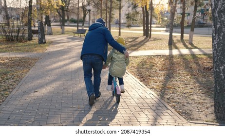 Joyful Father Teache Little Child Ride Two-wheeled Bike Happy Family, Childhood Dream Drive Bicycle Kid Dad Play Merrily City Park, Baby Spins Pedals Wheels, Parent Engaged Horse Riding With Daughter