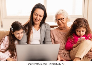 Joyful female multigenerational family with laptop watching videos online Indoors at home living room. Family, affectionate, reunion, together concept. - Powered by Shutterstock