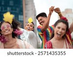 Joyful friends dancing and celebrating Brazilian Carnival in vibrant costumes outdoors. Energetic group of people enjoying festive parade in urban street of Brazil