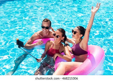 Joyful Friends Making Selfies In A Swimming Pool