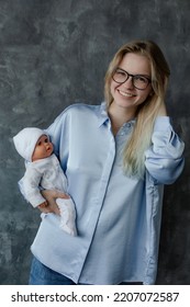 Joyful Future Mother Take Birth Preparation Course, Gray Wall Background, Free Copy Space. Successful Mastering Of Practical Skills Of Newborns Care. Training For Pregnant Women, Practice On Doll.