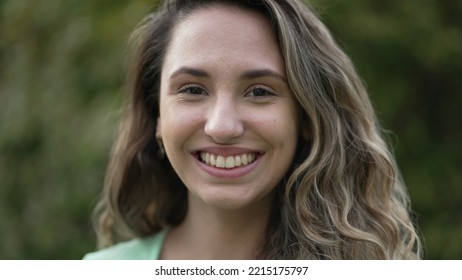 Joyful Hispanic Latina Girl Standing Outside Smiling. Young Woman Latina Portrait. Millennial 20s Female Person In Tracking Shot