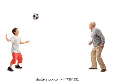 Joyful Kid Playing Soccer With His Grandfather Isolated On White Background