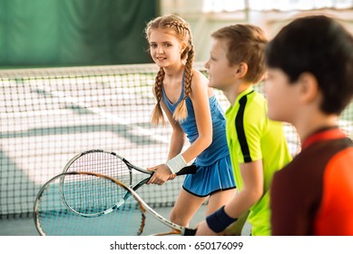 Joyful kids having fun on tennis court