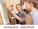 Joyful kids painting in the art school