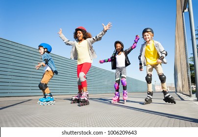 Joyful kids rollerblading outdoors at sunny day - Powered by Shutterstock