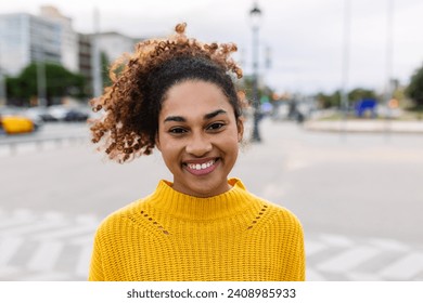 Joyful latin american student girl smiling at camera outdoors. Portrait of happy young multiracial woman over urban background - Powered by Shutterstock