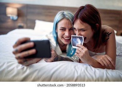 Joyful Lesbian Couple Announcing A Pregnancy Test Results Together