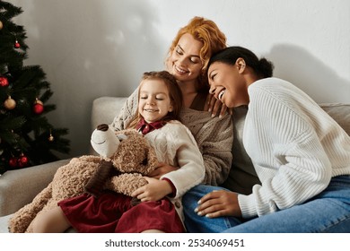 A joyful lesbian couple hugs their daughter at home, celebrating their loving family. - Powered by Shutterstock