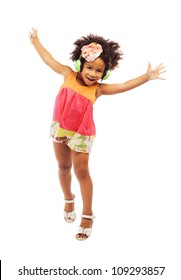 Joyful little girl in headphones is jumping