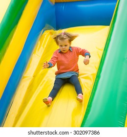 Joyful little girl playing on a trampoline. - Shutterstock ID 302097386