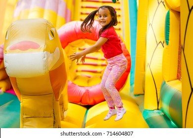 Joyful little girl playing on a trampoline. - Shutterstock ID 714604807