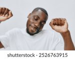 joyful man dancing, happiness, celebration, music enjoyment, casual white t shirt, studio background, positive emotions, energetic movement, focus on expression, vibrant atmosphere