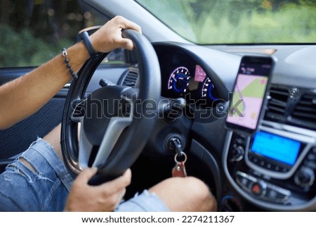 Joyful man driving car, using mobile phone with map gps navigationgoing on trip during summer vacation, Handsome man with beard buying and renting a car, Navigation auto location system app