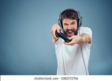   joyful man with headphones on his head with a joystick                              - Shutterstock ID 1082572706