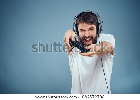   joyful man with headphones on his head with a joystick                             