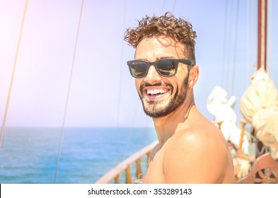 Joyful man take self portrait on exclusive luxury sailing boat. Concept of friendship and travel with young people. Happy guy spending time with friends during summer trip with bright sunny color tone