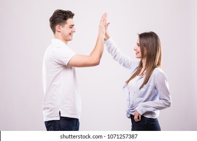 Joyful Man And Woman Greeting Each Other With A High Five Isolated On White Background