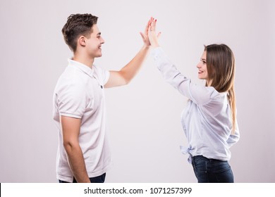 Joyful Man And Woman Greeting Each Other With A High Five Isolated On White Background