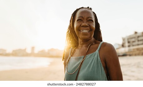 Joyful mature woman with braided hair enjoying a beautiful beach sunset. Capturing moments of happiness and relaxation. - Powered by Shutterstock