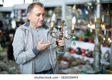 Joyful Middle Aged Man Buying Retro Handicrafts On Indoor Flea Market