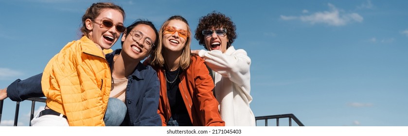 Joyful Multicultural Friends In Stylish Sunglasses Looking At Camera Outdoors, Banner