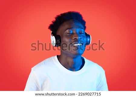 Similar – Young black man listening to music