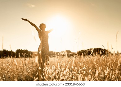 Joyful Person Raising Arms morning  in Rural Field Under Summer Sunlight