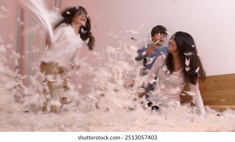 Joyful Pillow Fight With Mother And Children In A Bedroom, Feathers Flying Everywhere, Capturing A Fun And Energetic Moment Of Family Bonding And Laughter Amidst The Chaos Of Playful Activity - Powered by Shutterstock