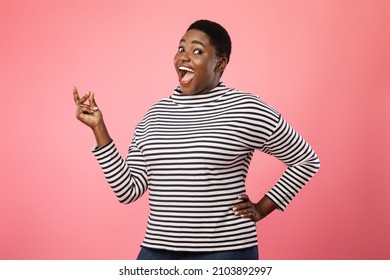 Joyful Plus-Sized African American Female Snapping Fingers Smiling Looking At Camera Standing Over Pink Studio Background. Excited Woman Gesturing Clicking Fingers. It's Easy Concept - Shutterstock ID 2103892997