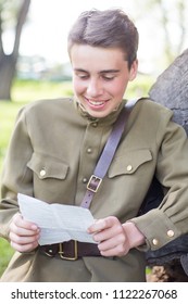 Joyful Russian Soldier Reading A Letter Outdoors