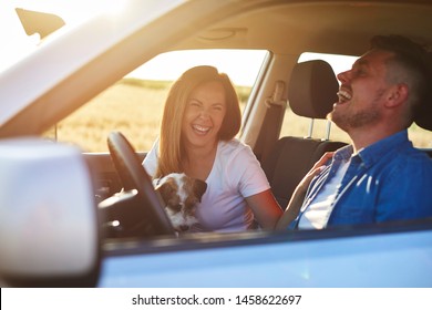 Joyful Scene Of Young Couple And Dog During Road Trip 