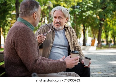 Joyful Senior Male Friends Enjoying Hot Beverage Outdoor