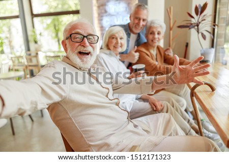 Joyful senior man spending time with friends stock photo Stock foto © 