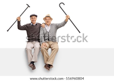 Joyful seniors with walking canes sitting on a panel isolated on white background