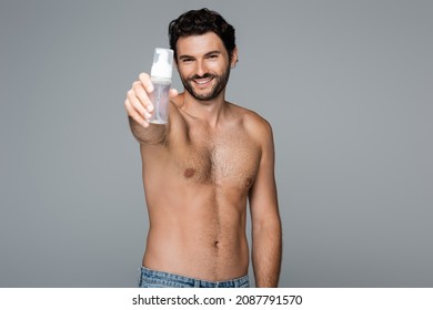 Joyful And Shirtless Man Holding Foam Cleanser Isolated On Grey