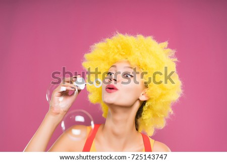 Joyful teen girl blowing soap bubbles, holiday, birthday