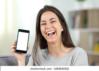 Joyful Teen Showing A Mockup Phone Screen To Camera Sitting On A Couch In The Living Room At Home